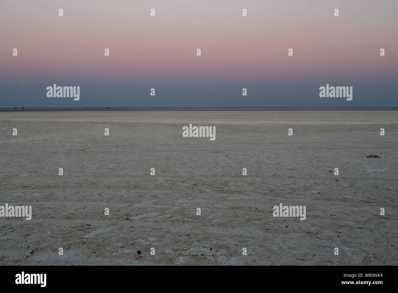Tramonto in sale di Makgadikgadi Pan - orizzonte al Tramonto Romantico - svuotare la Piana e colorati di cielo a Twylight Foto Stock