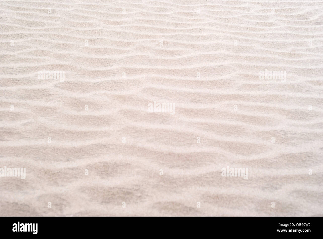 Sfondo - dune del deserto vicino, increspature sulla superficie di sabbia Foto Stock