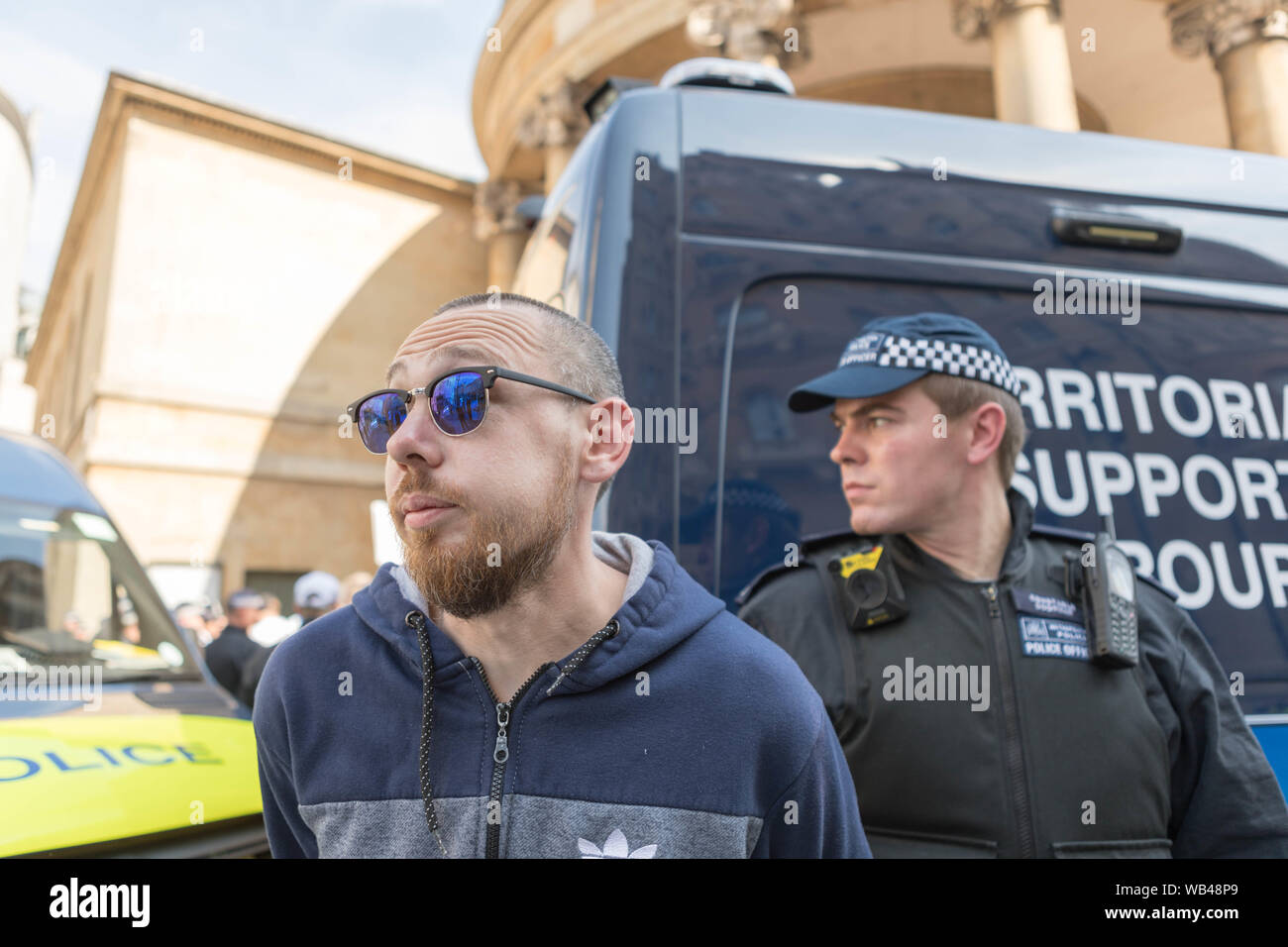 Portland Place, Londra, Regno Unito. 24 Ago, 2019. Un manifestante viene arrestato dalla polizia. Libera Tommy Robinson protesta al di fuori della BBC. Allo stesso tempo una dimostrazione del contatore avviene, organizzato da Stand fino al razzismo e di unire le forze contro il fascismo. Penelope Barritt/Alamy Live News Foto Stock