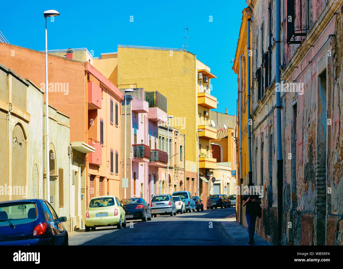 Street view su strada con auto parcheggiate in Cagliari in Sardegna in Italia. Quartiere urbano Foto Stock