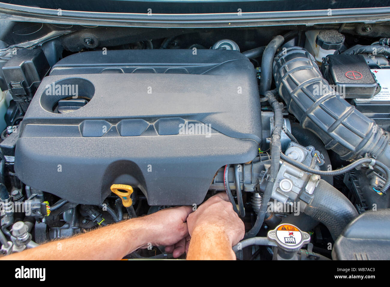 La mano visibile di un meccanico. Meccanico ripara motore auto. Moderno motore diesel. Foto Stock