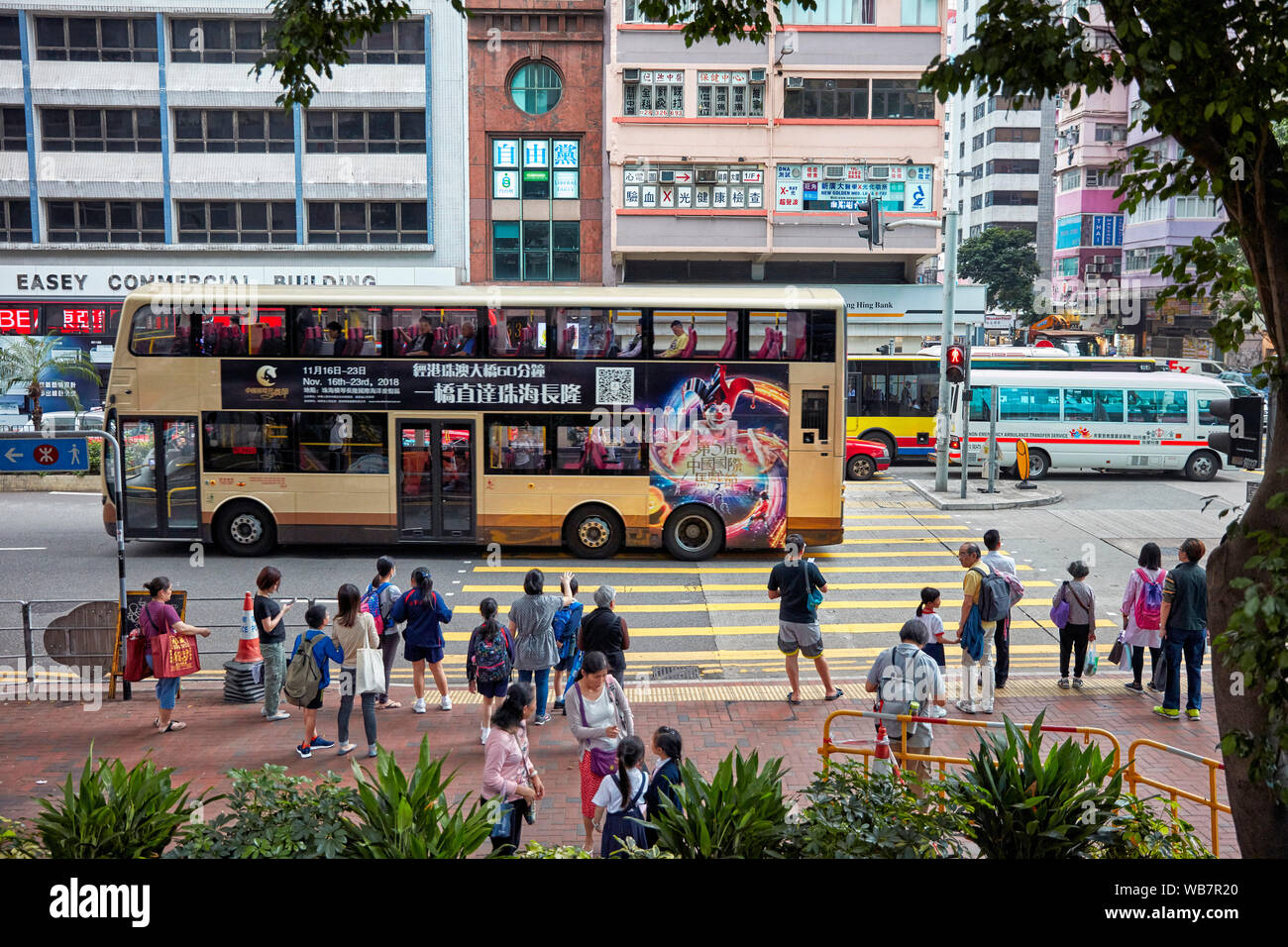 Le persone in attesa di luce verde all'attraversamento pedonale sulla strada Hennessy. La Causeway Bay di Hong Kong, Cina. Foto Stock