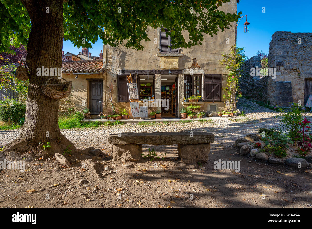 Vecchio negozio con weathered banco Pietra, adottate alla fine di un pomeriggio estivo la colata lunghe ombre, PEROUGES, Francia Foto Stock