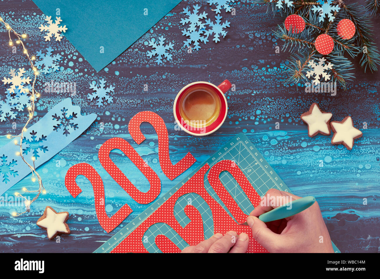 Concetto di sfondo inverno, carta artigianale con taglio a mano numero 2020, una tazza di caffè e le decorazioni di Natale. Appartamento laico, vista dall'alto sul Menta astratta col Foto Stock