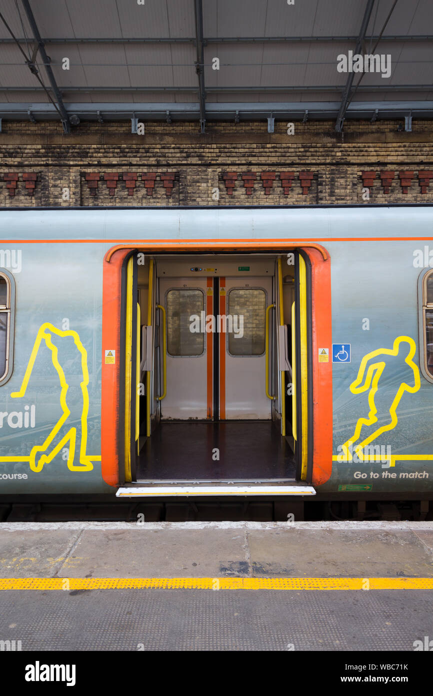 Aprire le porte su un treno di Merseyrail durante la sosta in corrispondenza di una stazione Foto Stock