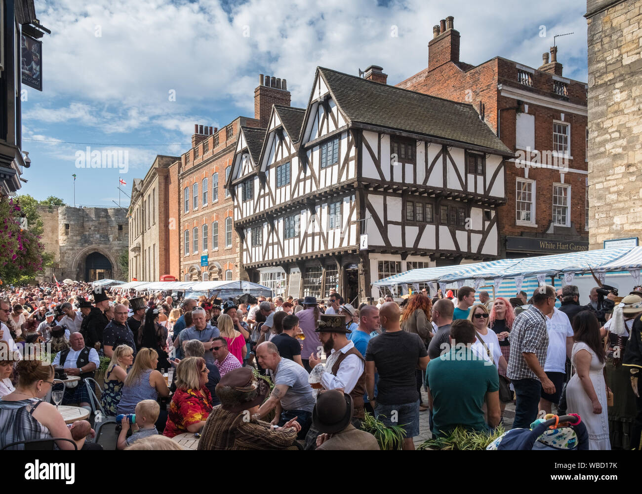 La folla si raccolgono nella storica piazza del mercato annuale di Lincoln Steampunk Festival, Agosto, Lincolnshire, Regno Unito Foto Stock