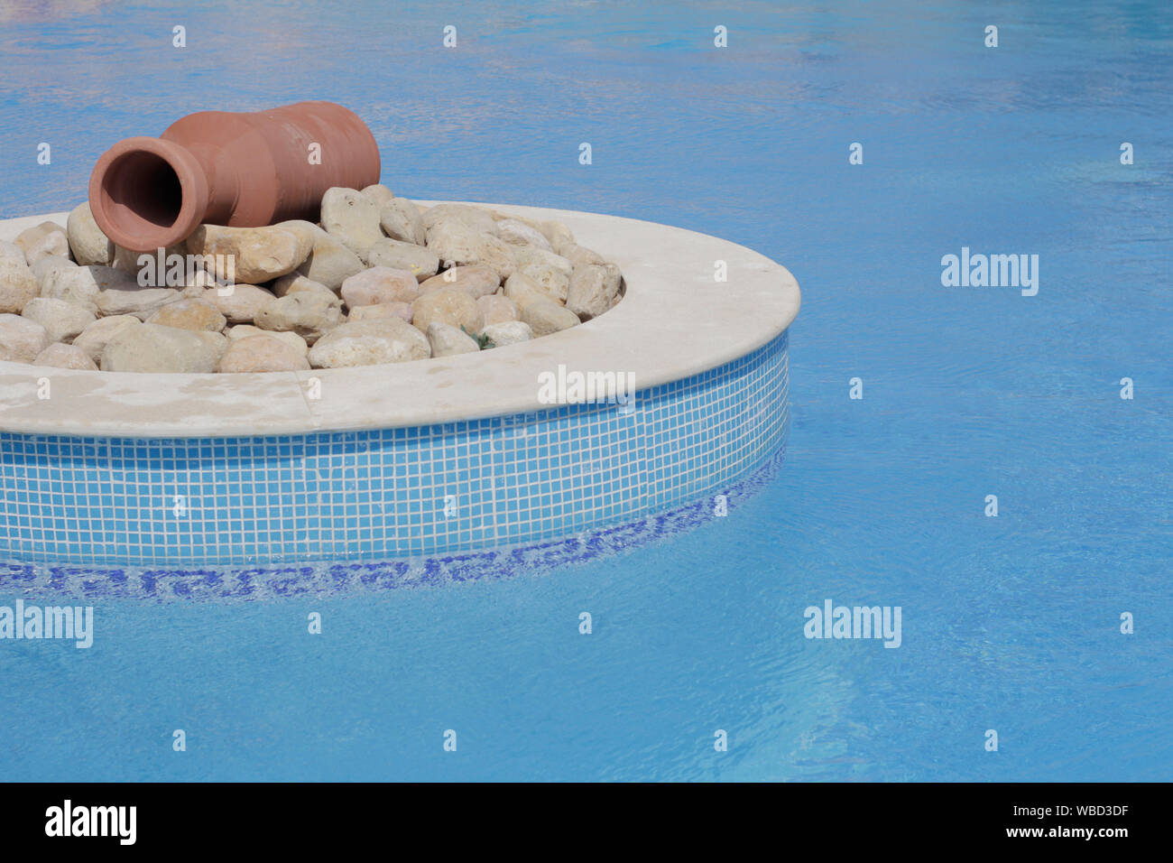 Isola di designer in piscina. Progettazione del pool. Brocca nel mezzo della piscina. Piscina Blu acqua increspata. Non vi è nessuno. Sfondo, cartolina. Foto Stock