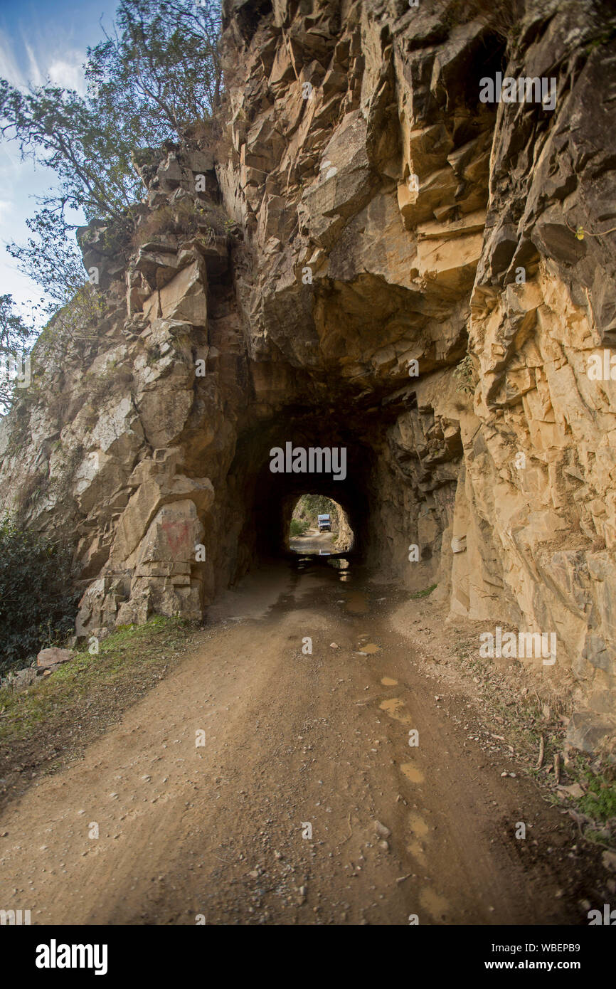 Stretti e bassi tunnel stradale attraverso la scogliera rocciosa sulla storica Old Coach Road che collega la città di Glen Innes a Grafton, NSW Australia Foto Stock