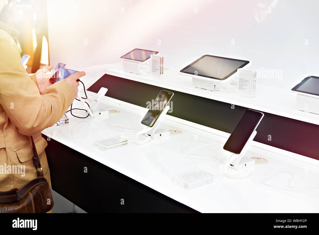 Acquirente mani con mobile smartphone in un negozio di elettronica Foto Stock