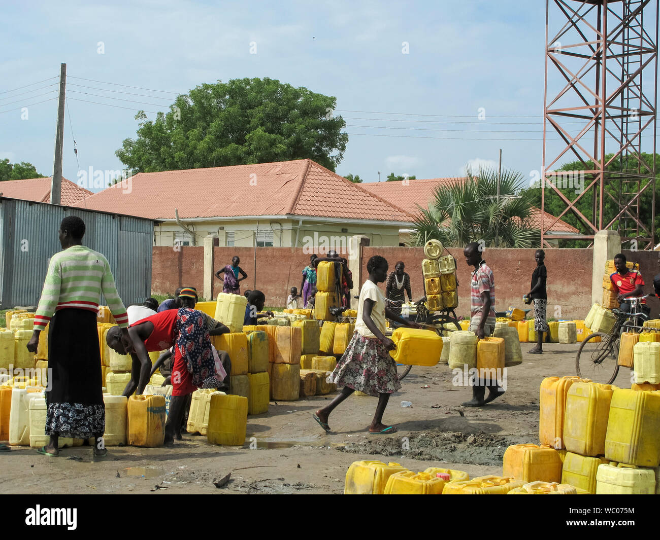 BOR, SUD SUDAN-Giugno 26, 2012: una folla di persone non identificate riempire brocche d'acqua in corrispondenza di una zona centrale di punto di acqua a Bor, sud Sudan Foto Stock
