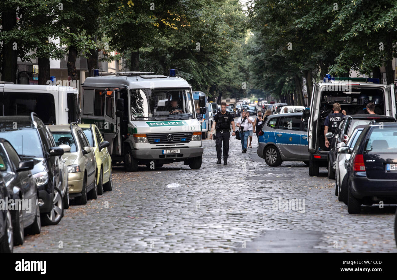 Berlino, Germania. Il 27 agosto, 2019. La polizia veicoli di emergenza sono parcheggiate in Weserstraße. Nel tardo pomeriggio vi è stata una rissa tra i membri della famiglia estesa. La polizia è arrivata con 100 ufficiali per dirimere la controversia. Nel corso del conflitto diverse persone attaccati tra loro con strumenti a percussione. Le parti della foto reso irriconoscibile per ragioni di diritti personali. Credito: Paolo Zinken/dpa/Alamy Live News Foto Stock