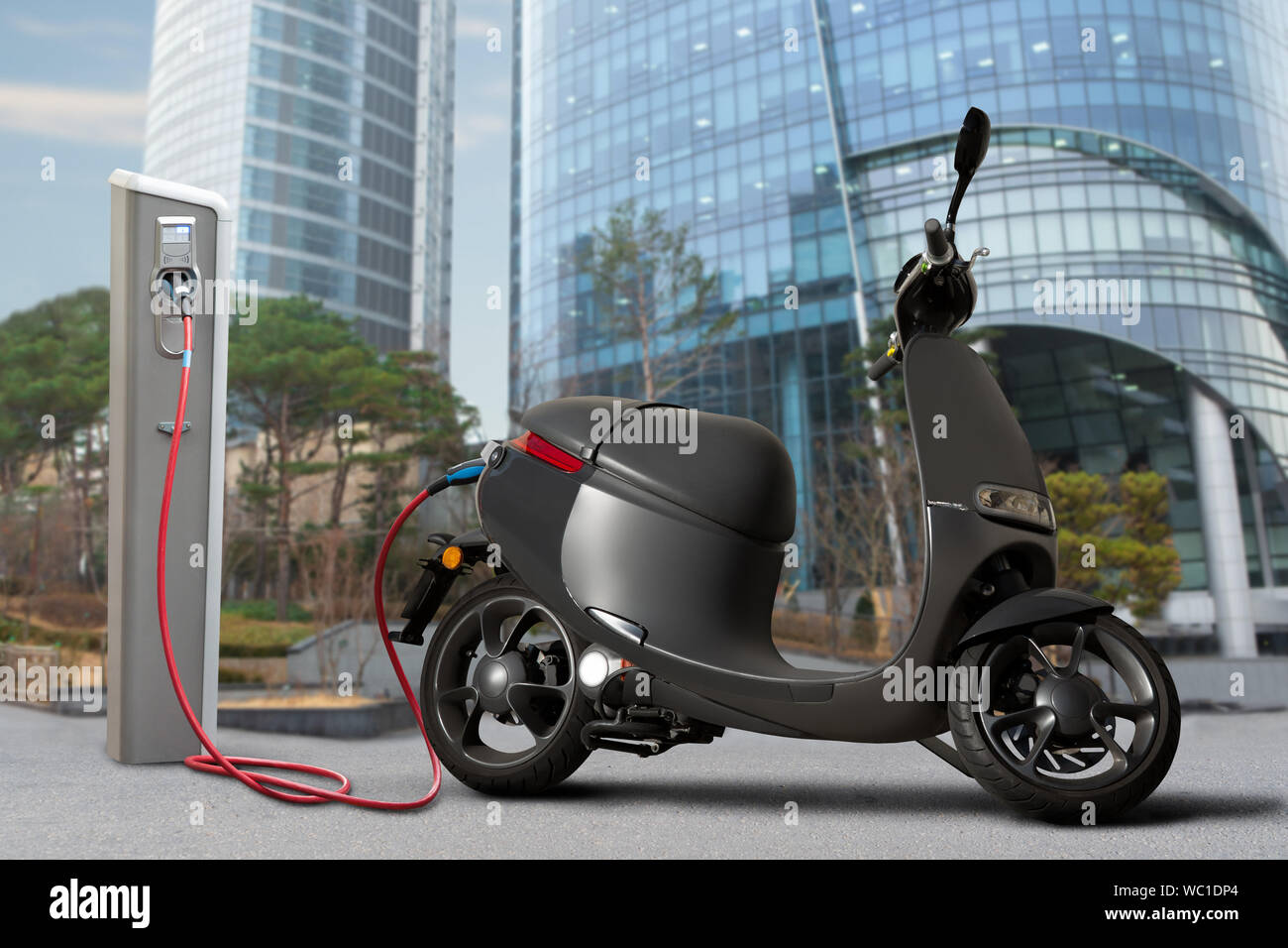Scooter elettrici per la condivisione con stazione di ricarica su una strada di città Foto Stock
