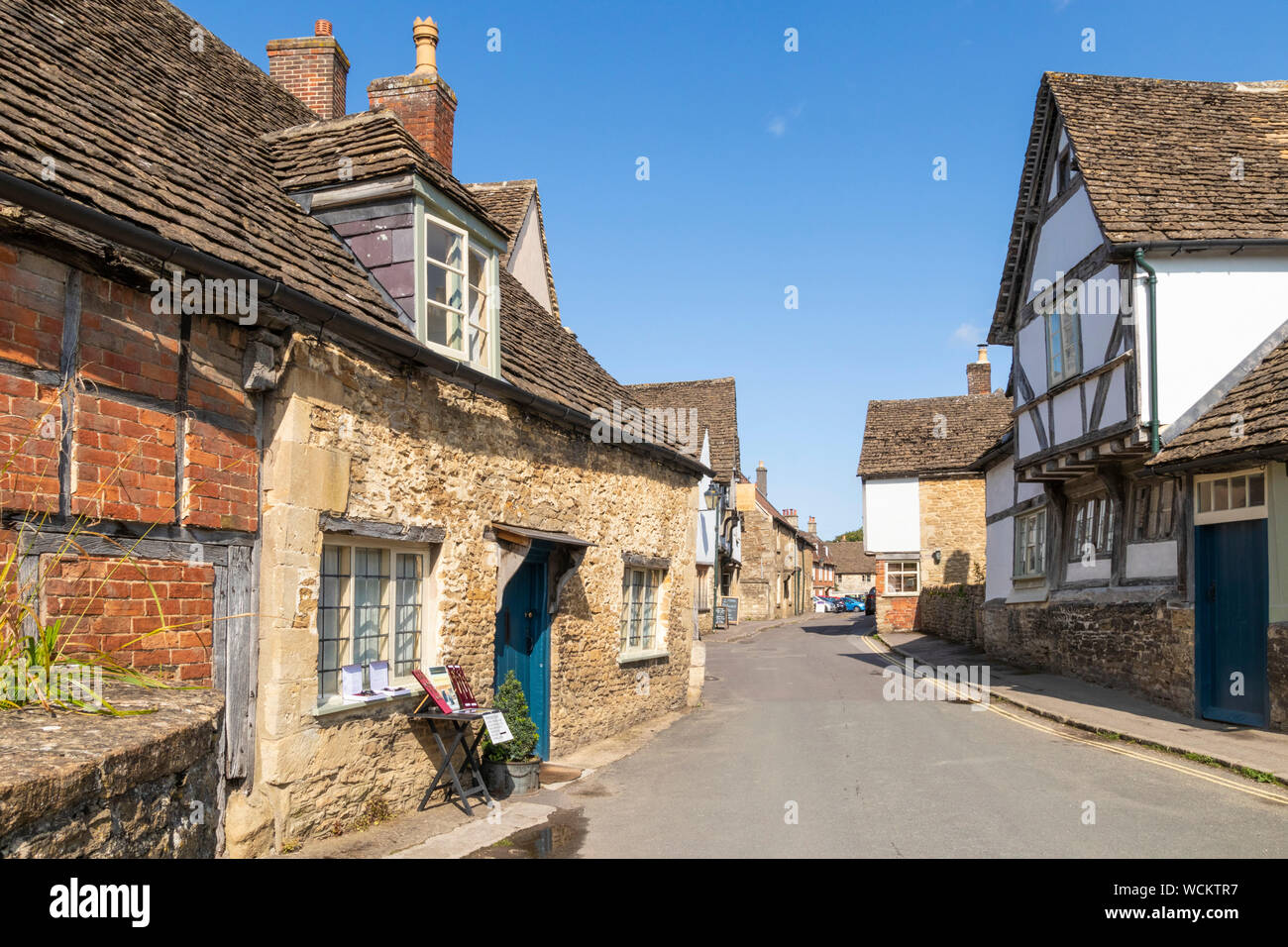 Vecchie case di sasso e metà degli edifici con travi di legno nel vecchio villaggio storico centro di Lacock village Wiltshire, Inghilterra UK GB Europa Foto Stock