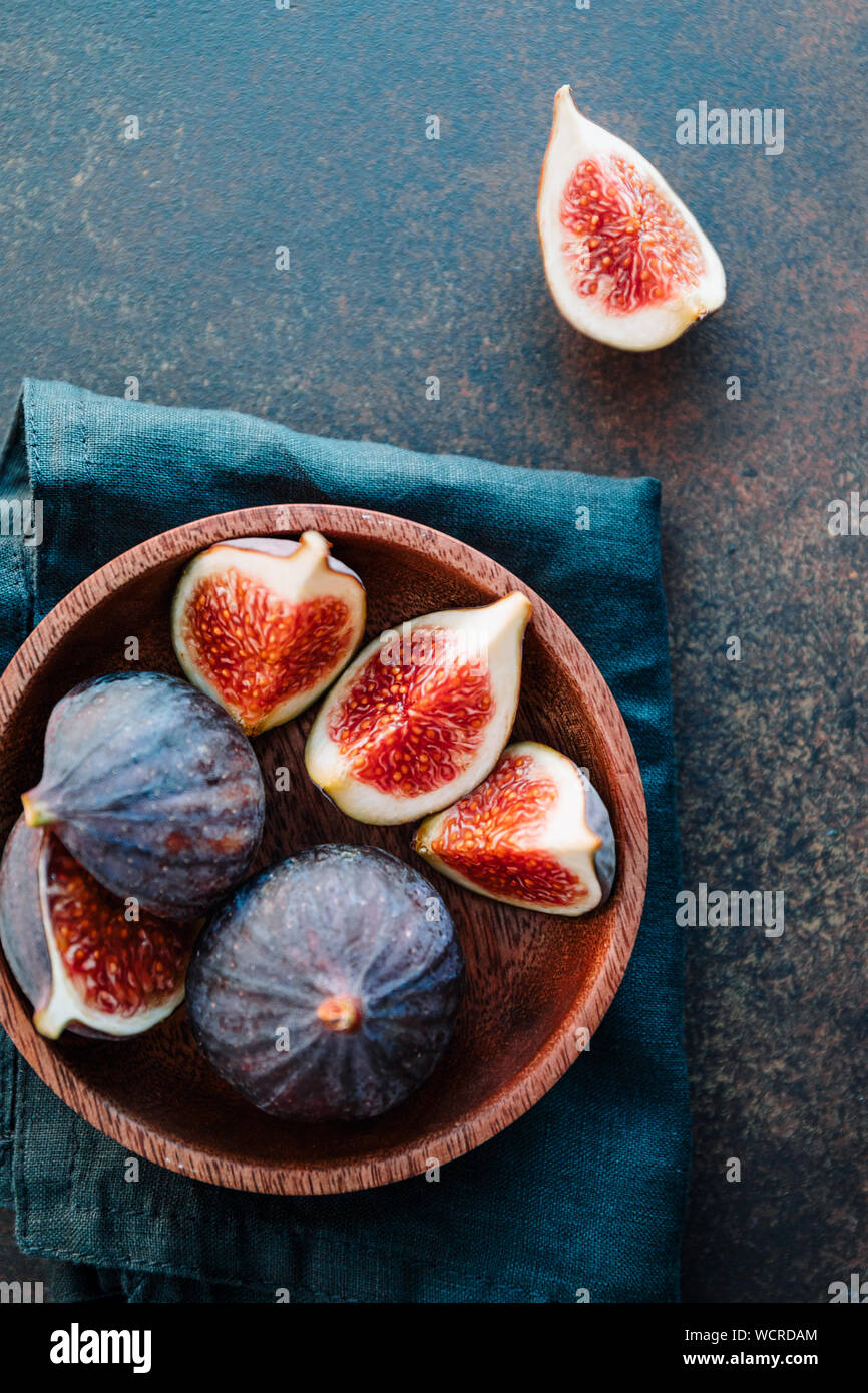 Vista dall'alto di ripe quartes figure in legno una piccola ciotola su una tabella. Foto Stock