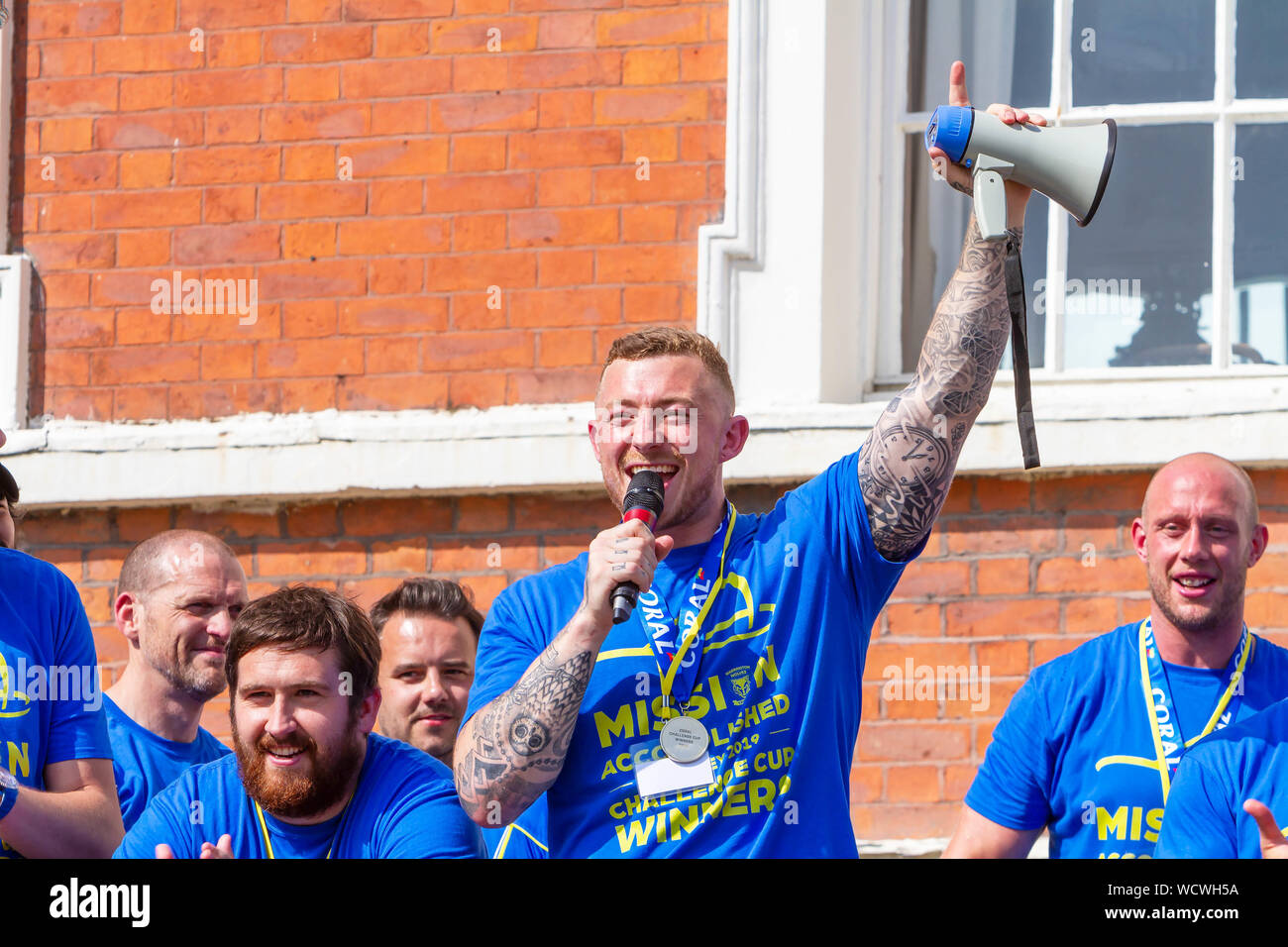 Warrington lupi portare il Coral Challlenge Cup torna home-Josh Charnley canta per le ventole Foto Stock