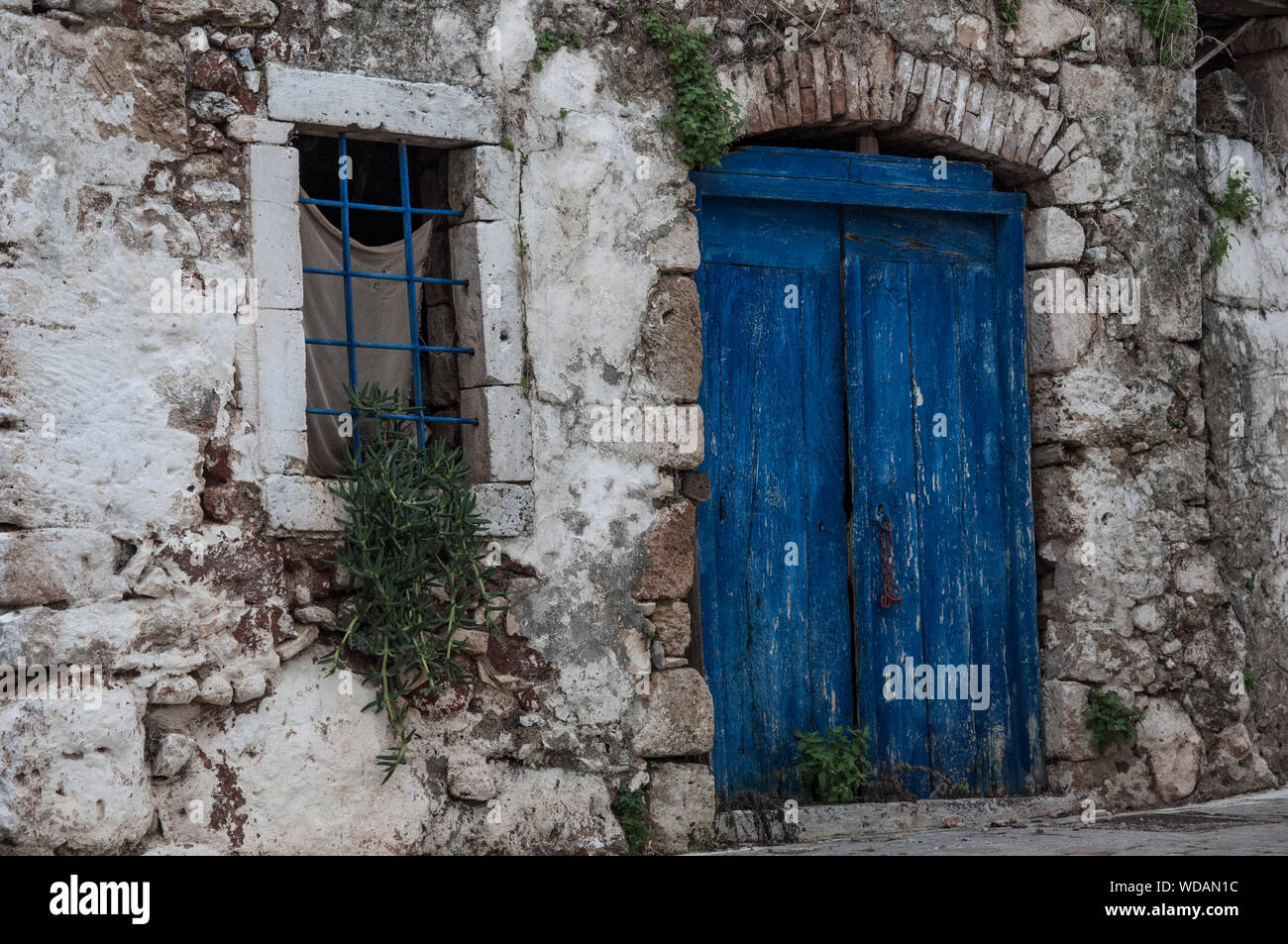 Un edificio antico e tradizionale blu porta nel villaggio di Koutouloufari Foto Stock