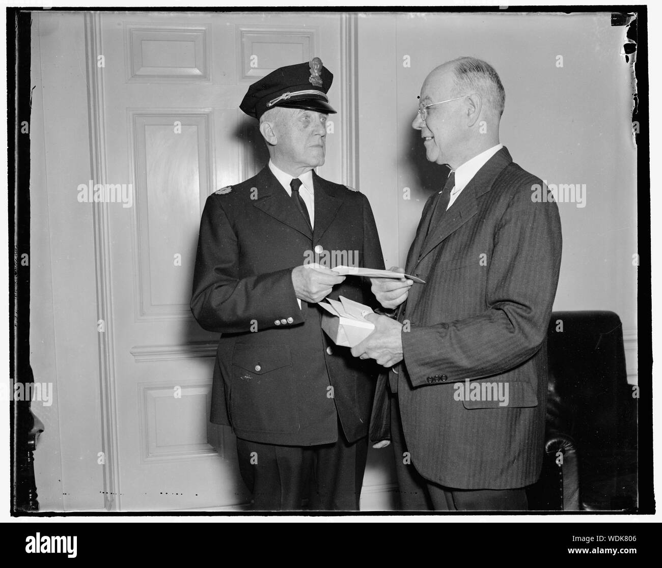 Dato portamonete sul pensionamento. Washington, 1 ottobre. Oggi in pensione dopo 36 anni di servizio alla Casa Bianca, Liet. Ernest Larry Seaman è presentato con una borsa da Capt. Clarence Dalrymple (sinistra) per conto della Casa Bianca forza di polizia e membri della forza esecutiva. La Casa Bianca della corrispondente associazione e nuovi fotografi ha anche presentato i gettoni di amicizia per il ritiro officer. 10/1/37 Abstract/medio: 1 negativi : vetro 4 x 5 in. o più piccolo Foto Stock