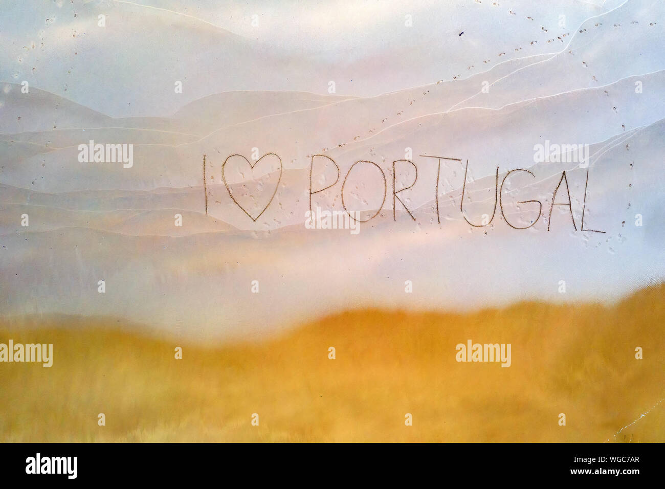 Io amo il Portogallo scritto nella sabbia in spiaggia Foto Stock