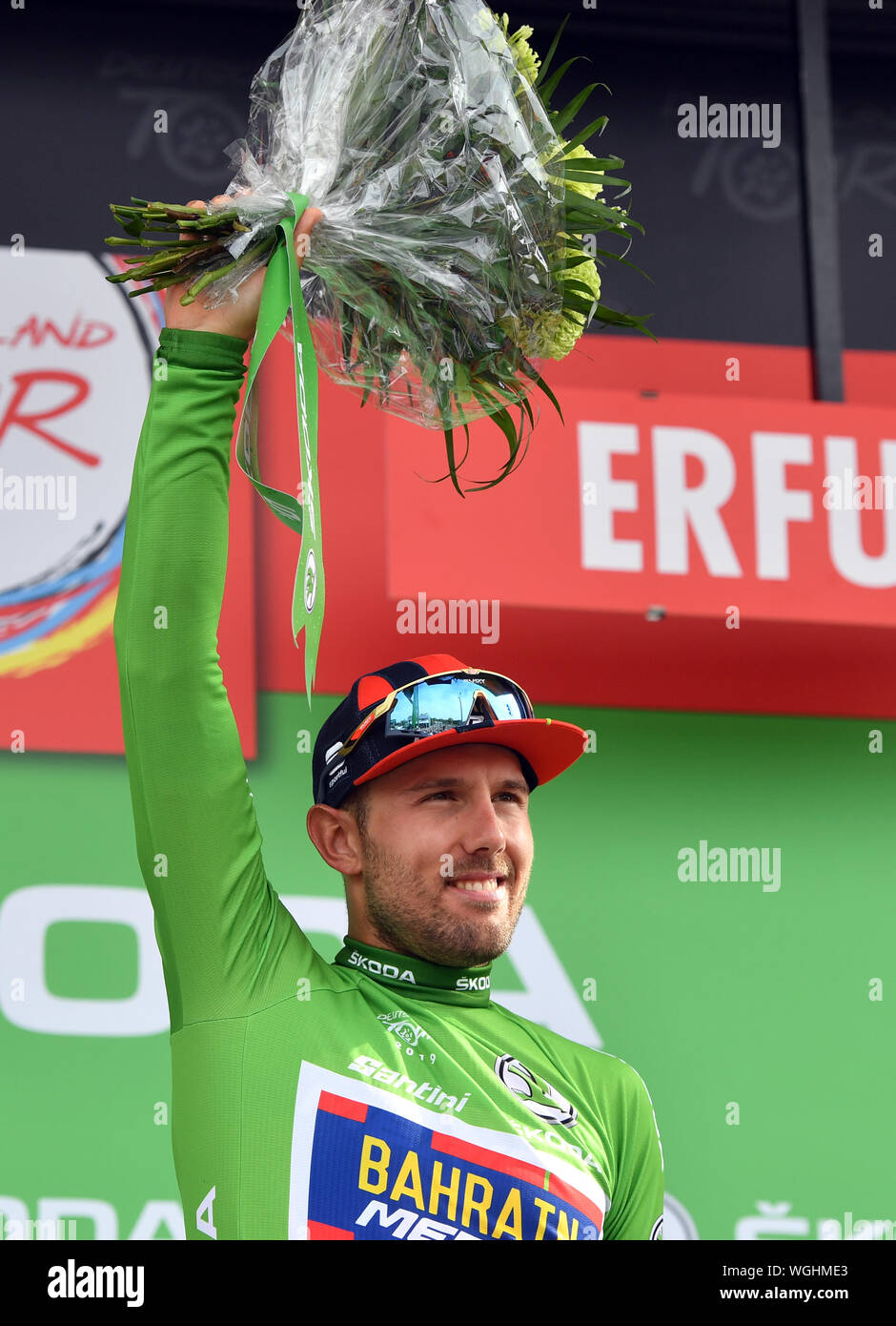 Erfurt, Germania. 01 Sep, 2019. Escursioni in bicicletta: UCI Europaserie - Germania Tour, fase 4, Eisenach - Erfurt (159, 50 km). L'Italiano Sonny Colbrelli del Team Bahrain-Merida cheers sul podio in maglia verde circa la vittoria della classifica sprint. Credito: Bernd Thissen/dpa/Alamy Live News Foto Stock
