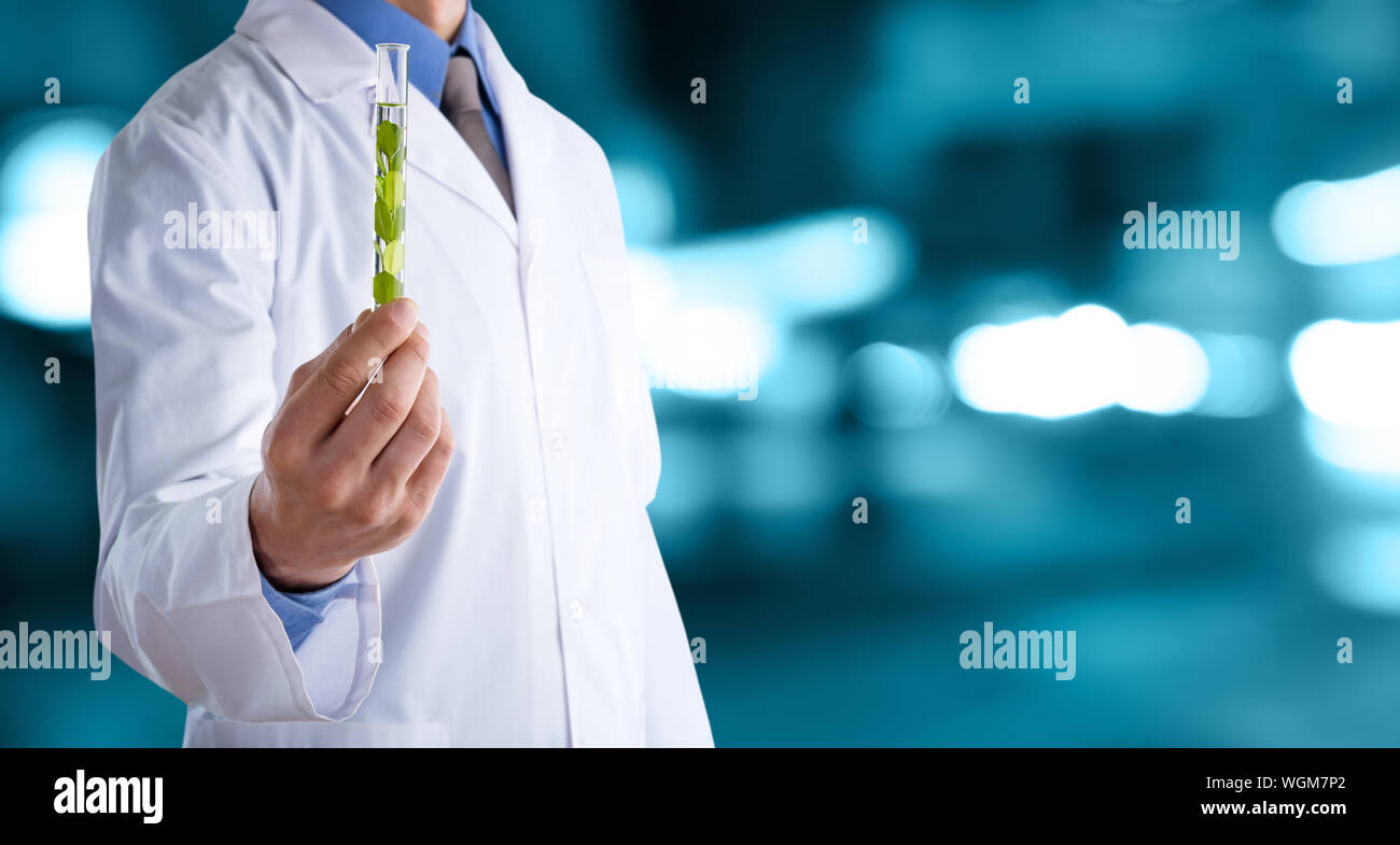 Medico uomo in camice bianco con uno stetoscopio su un abstract di sfocatura dello sfondo bokeh di fondo Foto Stock