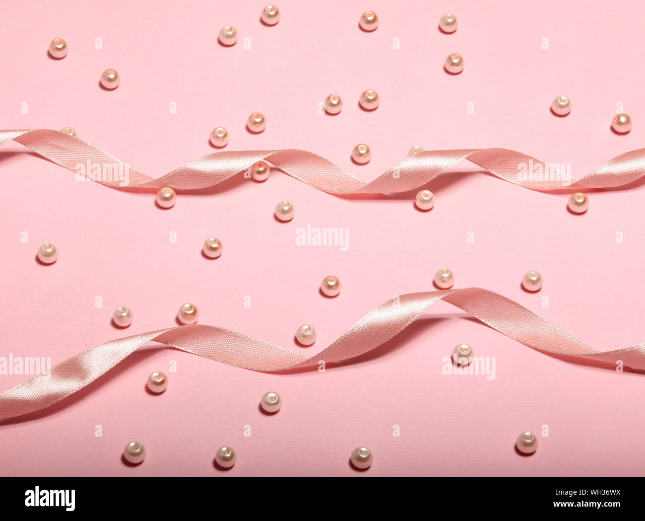 Nastro rosa e perle rosa su una superficie rosa che è adatto per lo sfondo.  È tutto sfondo rosa Foto stock - Alamy