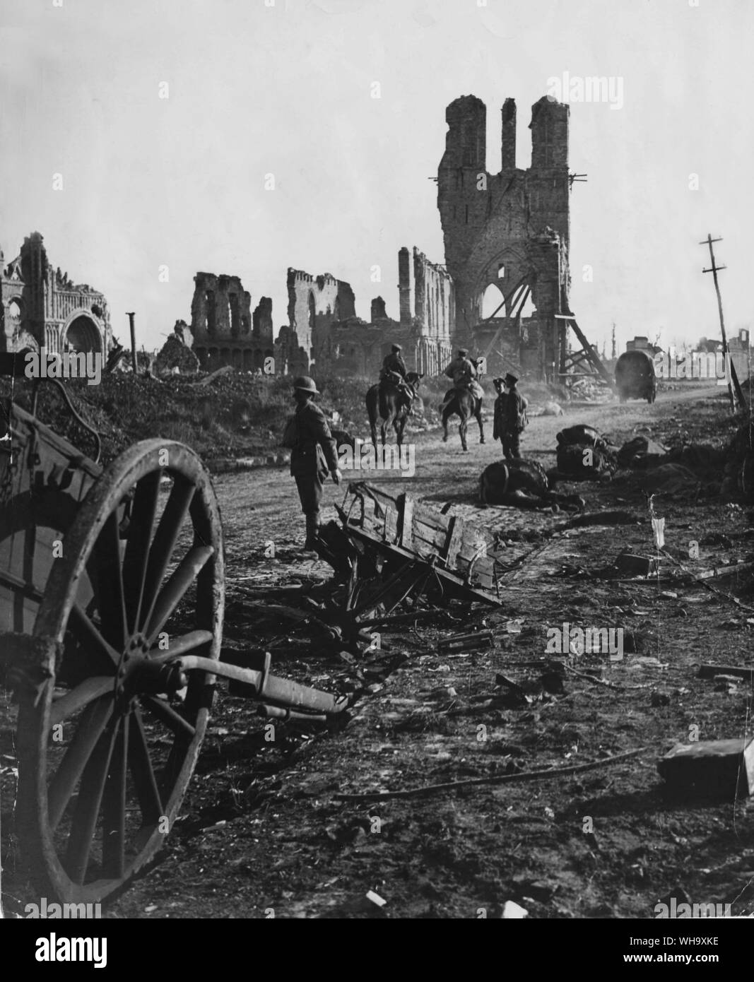 WW1: un camion e due cavalleggeri passano attraverso le rovine, vicino a Ypres, all'inizio dell'anticipo finale mediante gli eserciti alleati. Il gaunt guscio della città di Hall di stoffa è visibile sulla destra. In primo piano vi sono resti di munizioni limbers e cavalli catturati da shell-fuoco. Foto Stock