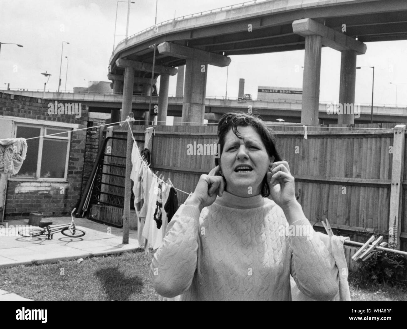 Onorevole Meah nel suo giardino con linea di lavaggio al di sotto di Birmingham Spaghetti Junction Foto Stock
