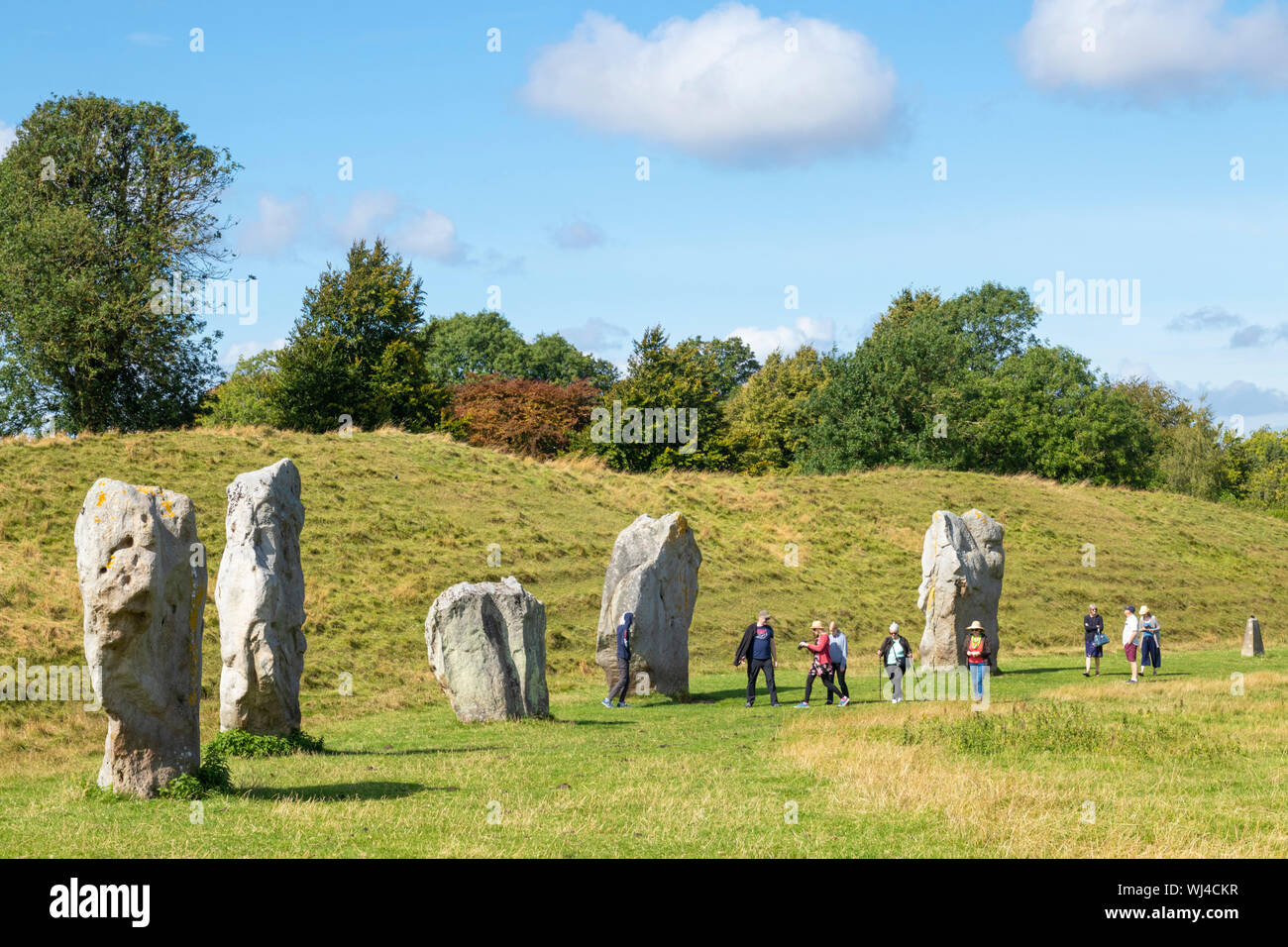 La gente a piedi in standing di Pietre di Avebury Stone Circle neolitico circolo di pietra di Avebury Wiltshire, Inghilterra UK GB Europa Foto Stock