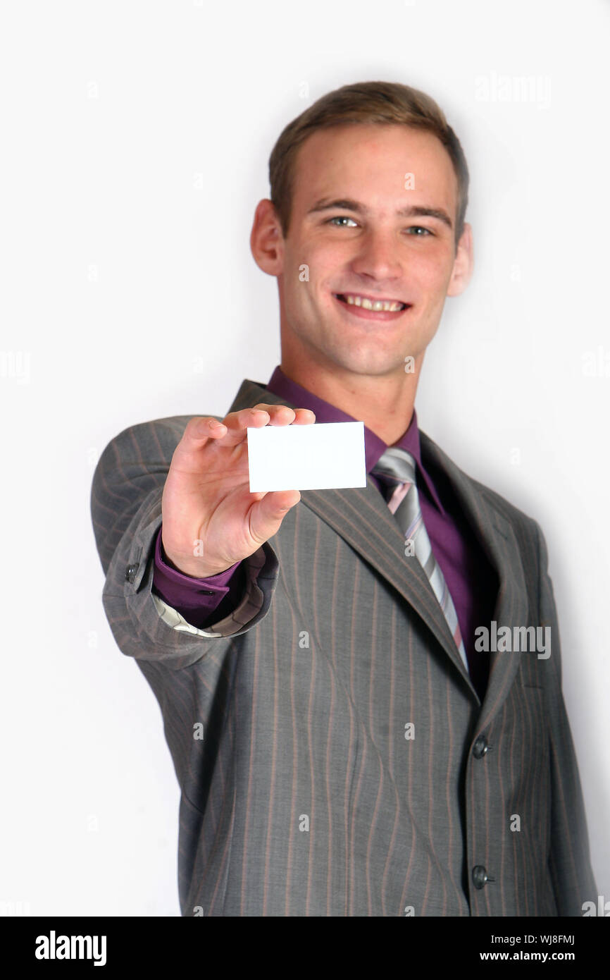 Freundlicher Businessmann lacht und hält eine leere Visitenkamera Foto Stock