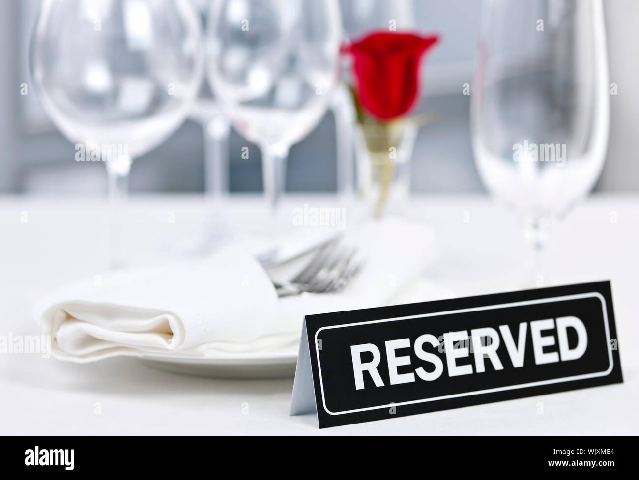 Riservati ristorante romantico messa in tavola con rose piatti e posate Foto Stock
