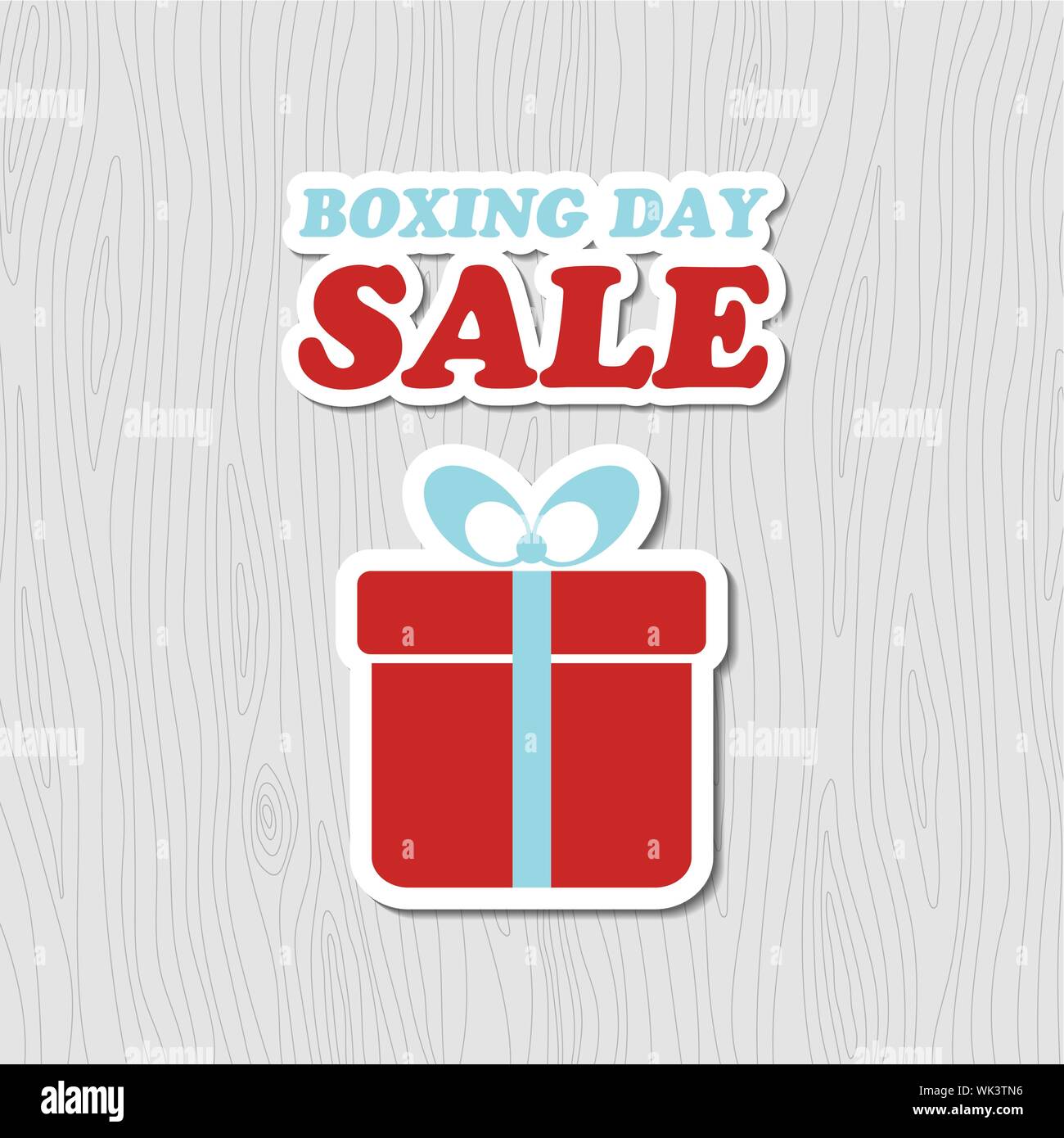 Boxing day vendita card. Banner di vettore con confezione regalo adesivo su uno sfondo di legno Illustrazione Vettoriale
