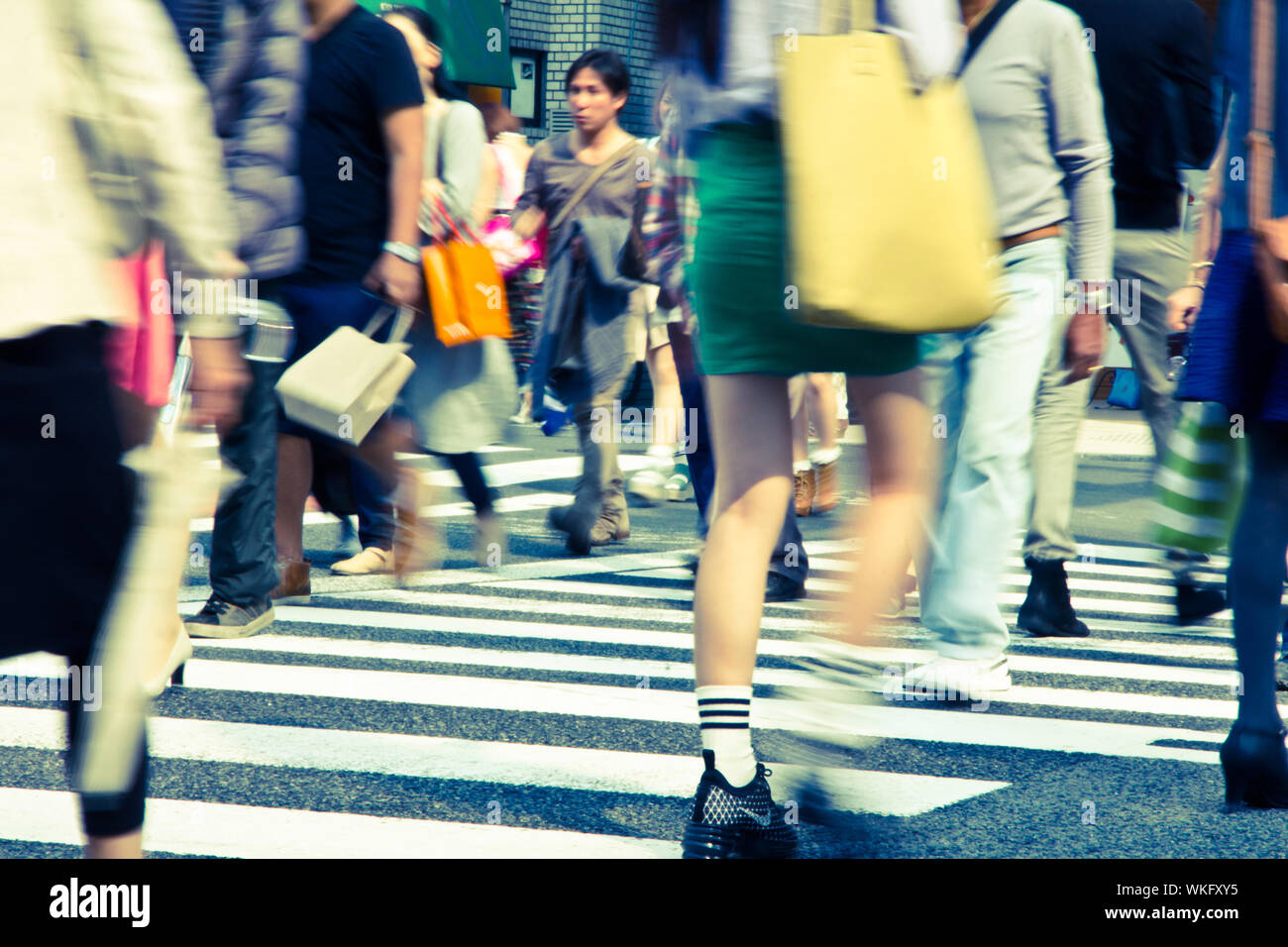 Turisti e uomini di affari che attraversando la strada a Harajiku Giappone Foto Stock