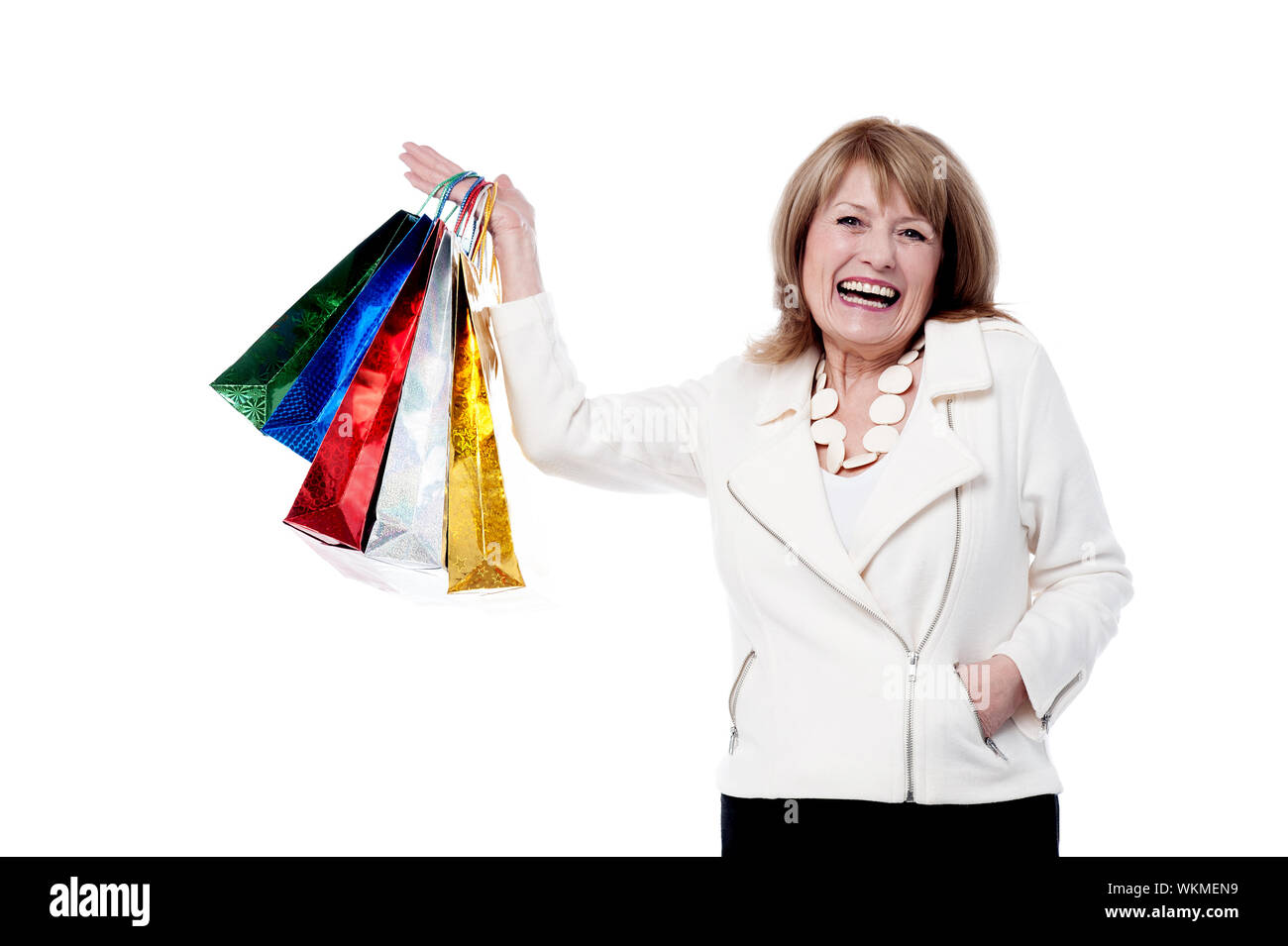 Senior donna le mani alzate con sacchetti colorati Foto Stock