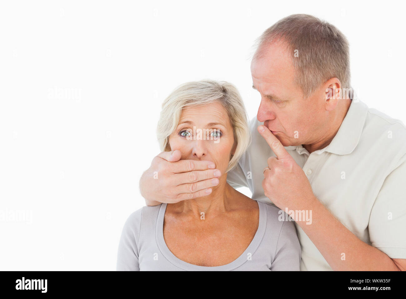 Silenziamento uomo la sua paura partner su sfondo bianco Foto Stock