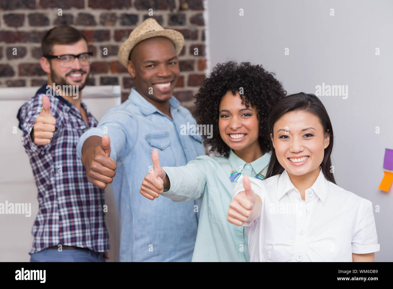 Ritratto di creative team business gesticolando Thumbs up in office Foto Stock