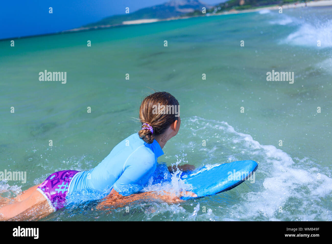 Ragazza adolescente in blu è divertente il surf Foto Stock