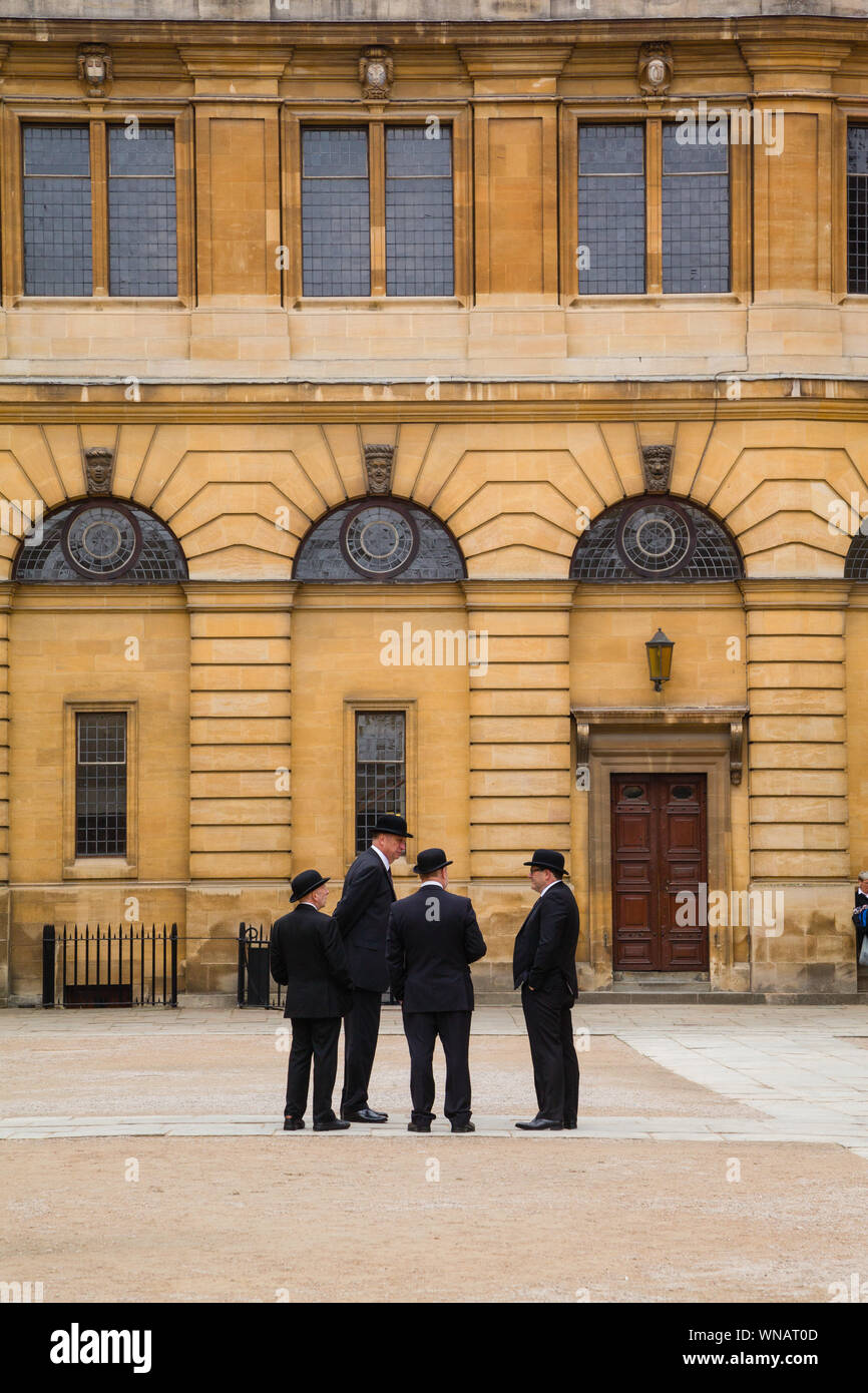 Le costabe della polizia dell'Università di Oxford o i Bulldogs di Oxford che indossano i cappelli bowler aspettano fuori della cerimonia annuale di Encaenia dal teatro Sheldonian Foto Stock