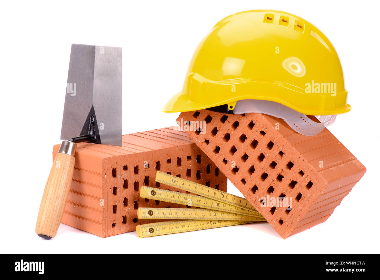 Strumenti e mattone come simbolo per la costruzione della casa Foto Stock