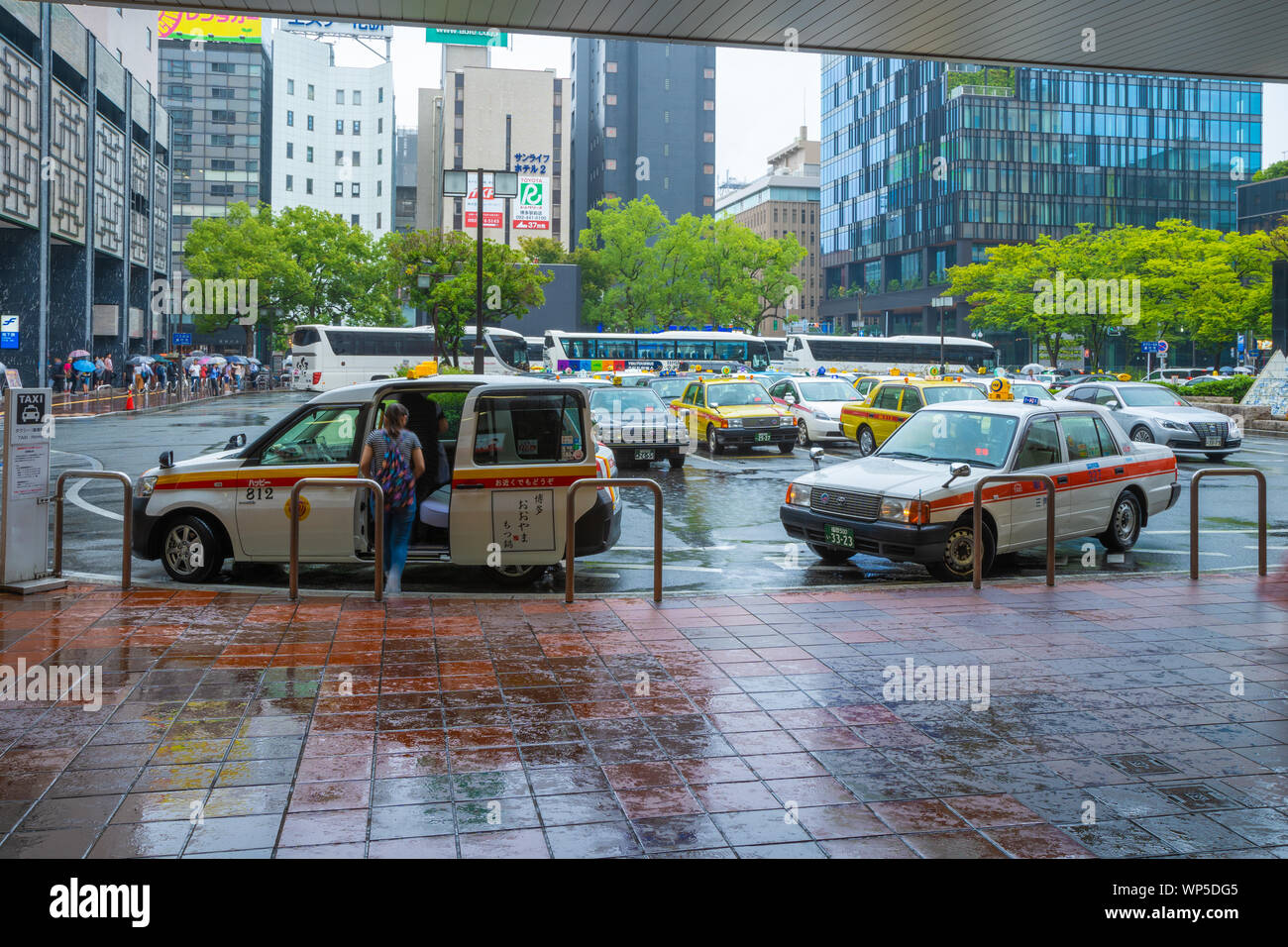 Fukuoka, Giappone - 13 Luglio 2019 - i Taxi stop per far salire e scendere passeggeri di fronte a una stazione ferroviaria edificio a Fukuoka, Giappone sulla luglio 13, 2019 Foto Stock