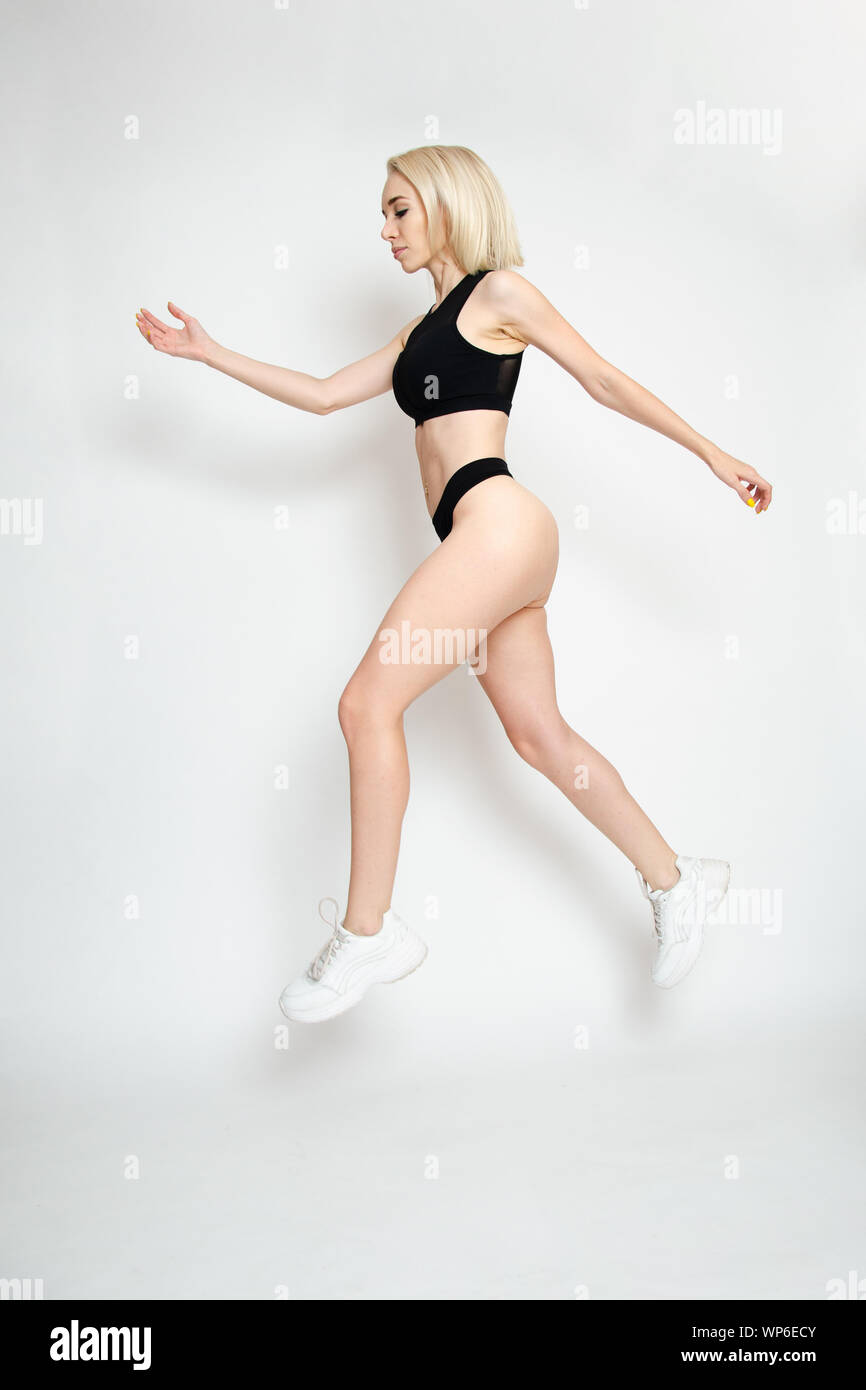 Modello femminile dalla Polonia. Attivo, ragazza giovane con fitness vestito. Donna di saltare in aria. Foto Stock