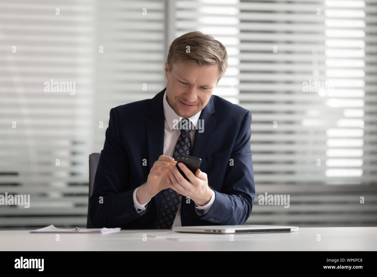 Felice fiducioso medio di età compresa tra i proprietari utilizzando la comunicazione interna azienda software. Foto Stock