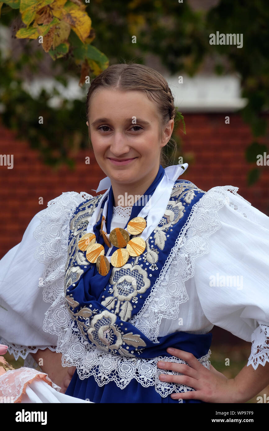 Ragazza vestita in costumi folcloristici andare in chiesa durante la Santa Messa il giorno del Ringraziamento in Stitar, Croazia Foto Stock