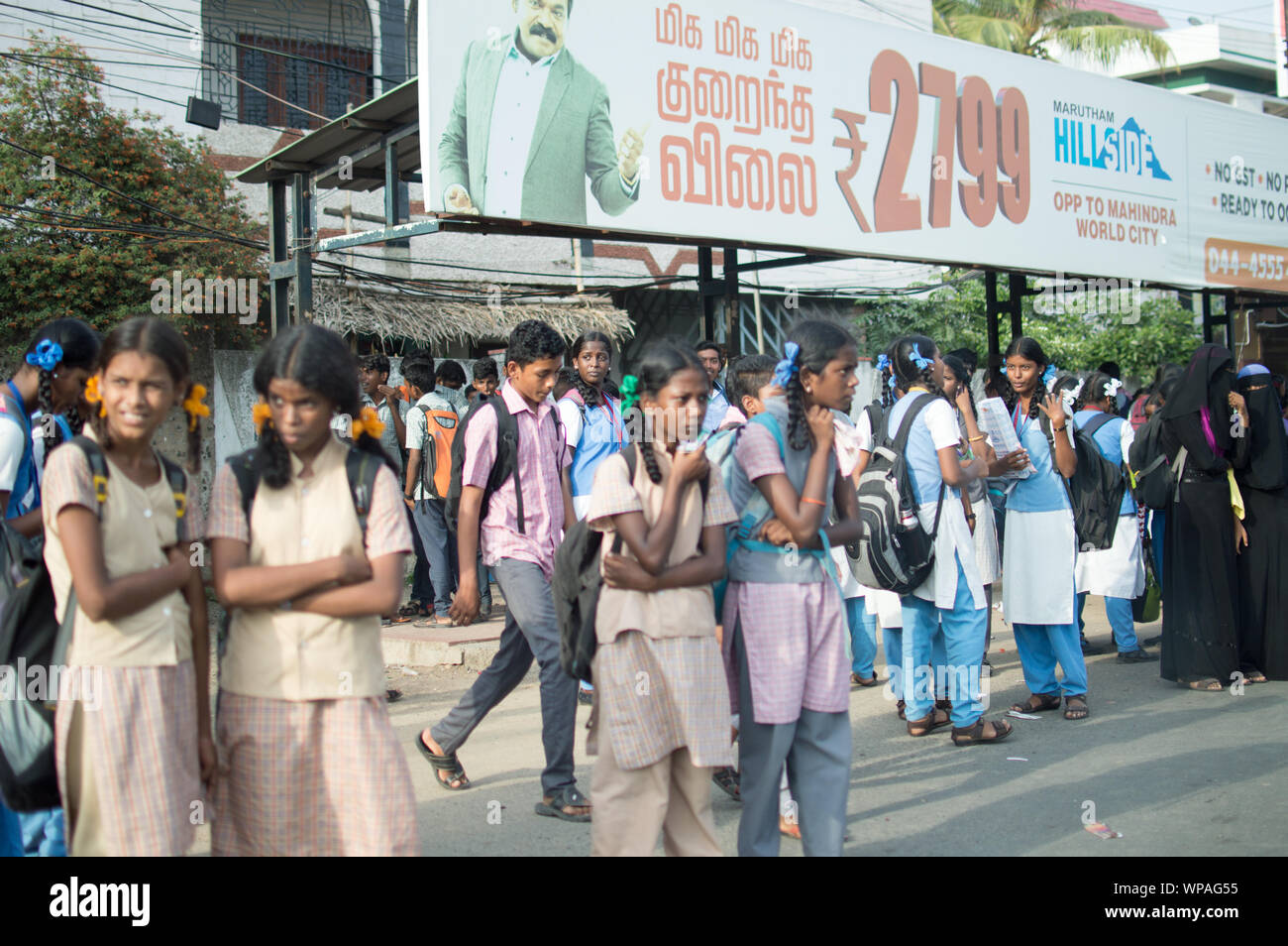 Un gruppo di ragazze della scuola in Chennai/Madras in attesa di un autobus pubblici in una fermata d autobus Foto Stock