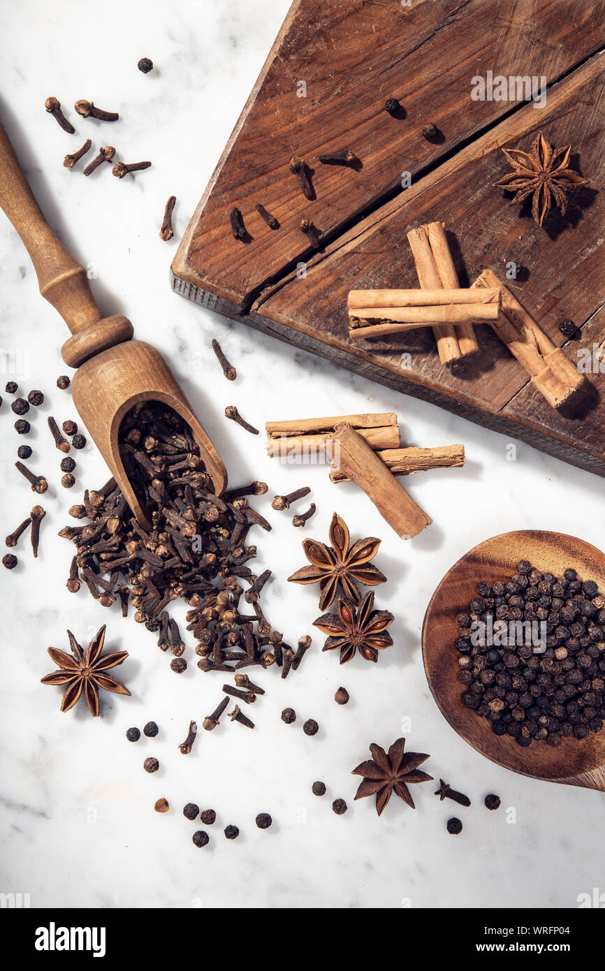 Set di spezie sulla tavola di marmo. Anice stellato, cannella, chiodi di  garofano e pepe nero per la cucina. Vista superiore Foto stock - Alamy