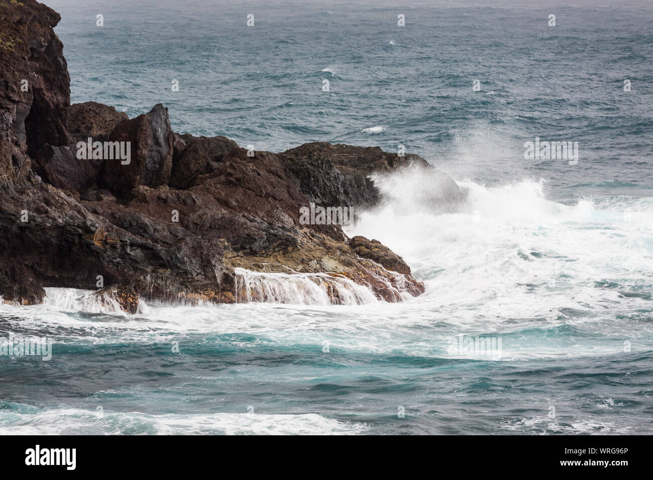 Vista in dettaglio di spruzzi delle onde di colpire le rocce a Playa de Nogales in La Palma, Spagna. Foto Stock