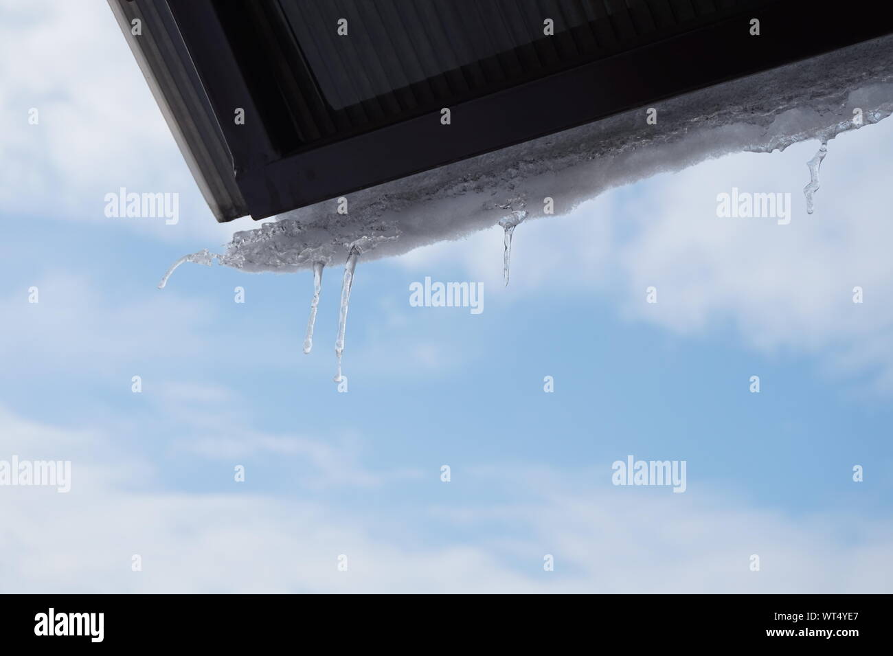 La primavera è alle porte: fusione di ghiaccio a fine inverno contro un cielo blu sullo sfondo Foto Stock
