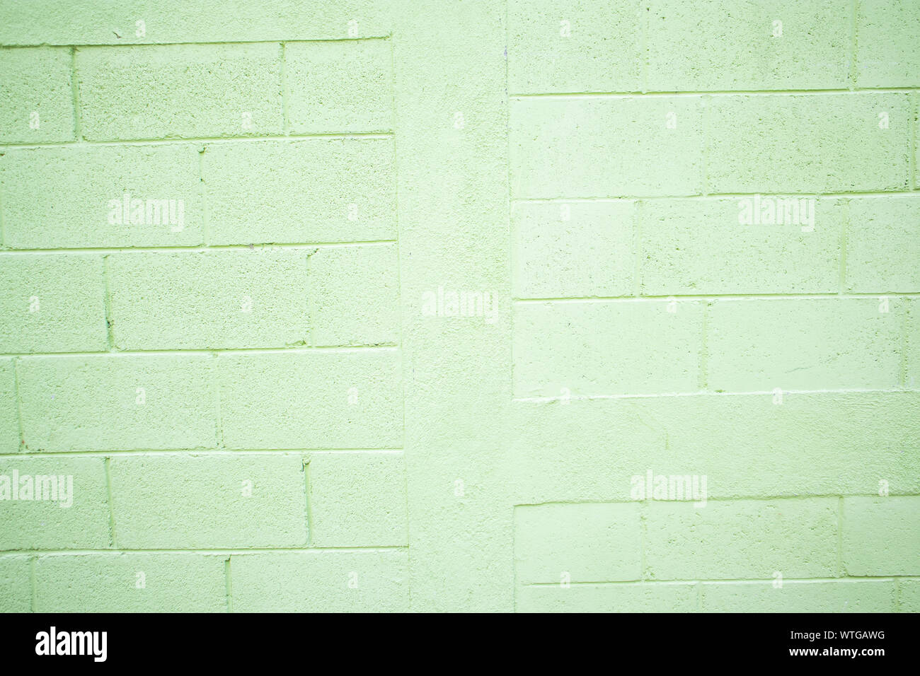 Blocco verde sullo sfondo della parete Foto Stock