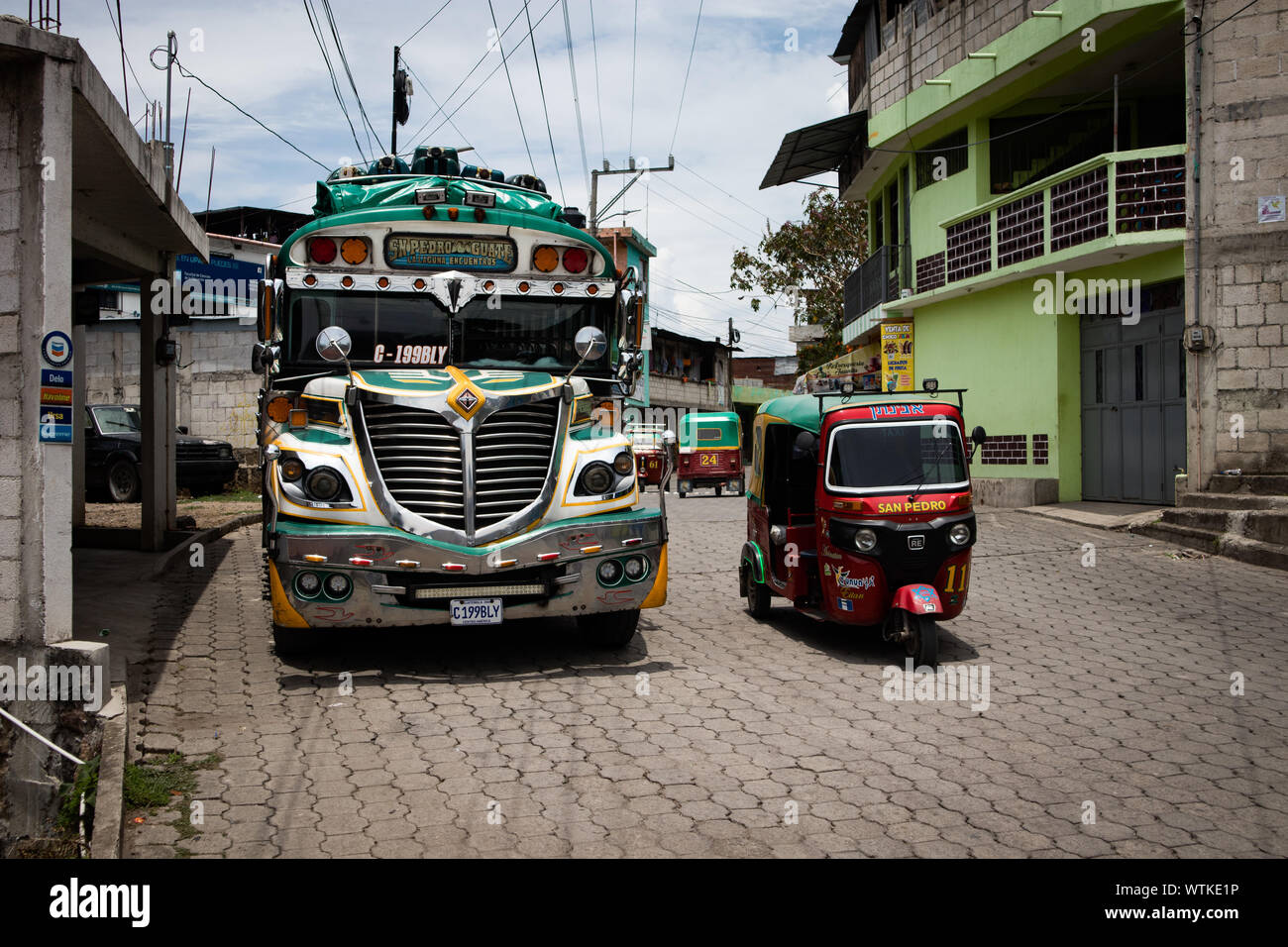 Modalità di trasporto in Guatemala includono un Tuk Tuk e autobus Foto Stock