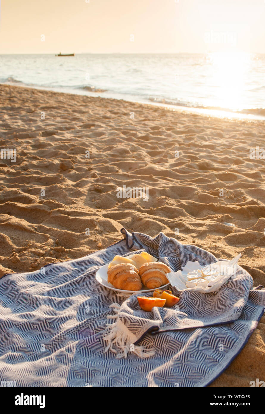 Picnic sulla spiaggia a sunrise. La vacanza estiva. Foto Stock