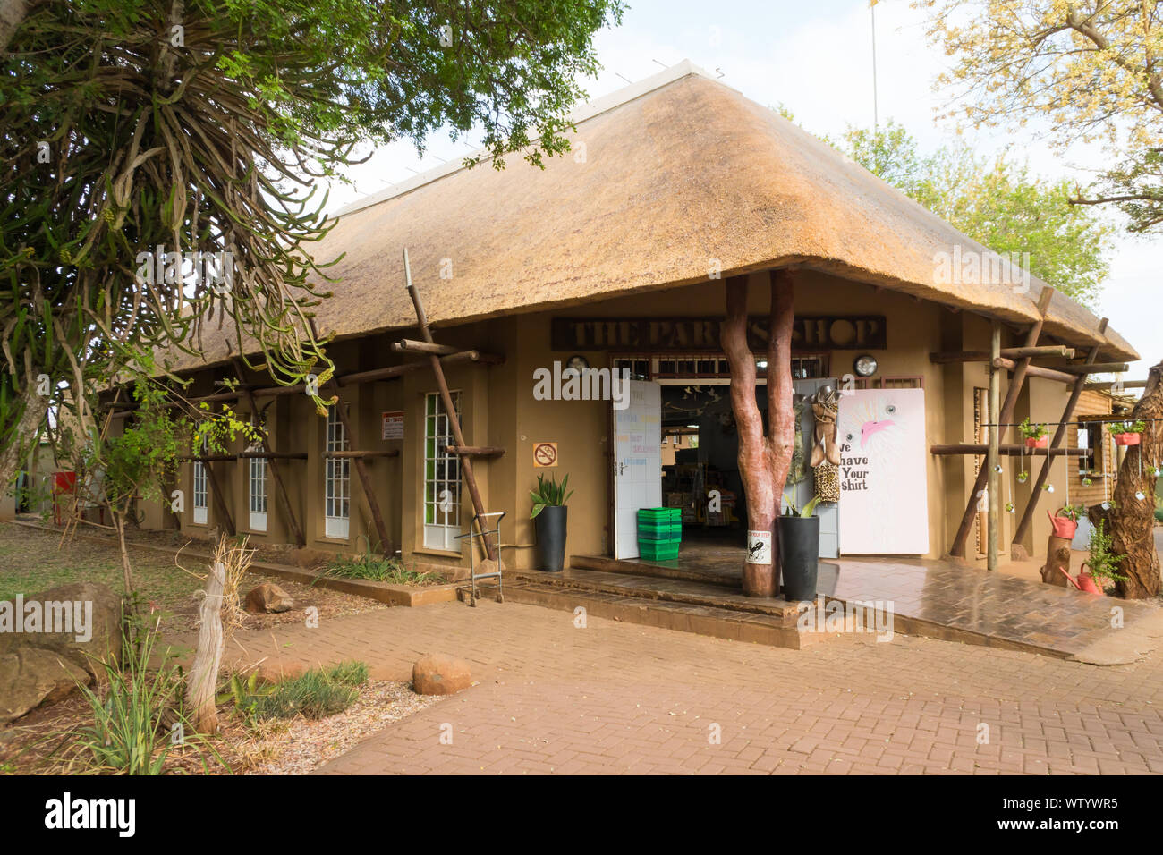 Ponte di coccodrillo resto camp shop o disposizioni store sotto il tetto di paglia nel Parco Nazionale di Kruger, Mpumalanga, Sud Africa Foto Stock